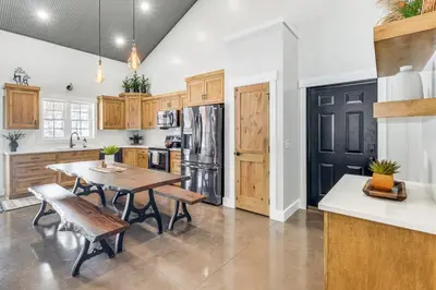 a kitchen with a table and chairs and a refrigerator at Family Retreat with Fire Pit and Yard in Mineral City in Mineral City