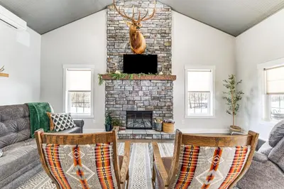 a living room with a couch and a fireplace at Family Retreat with Fire Pit and Yard in Mineral City in Mineral City