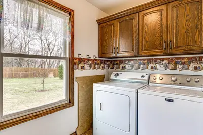 a kitchen with a washing machine and a window at Meadow Edges with Yard and Views in Odon in Sunman