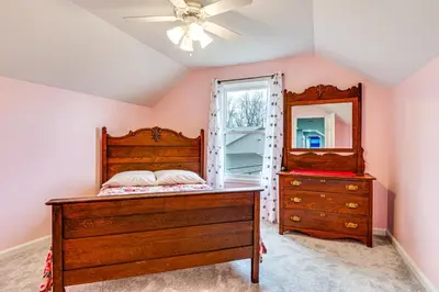a bedroom with a bed and a dresser and a mirror at Meadow Edges with Yard and Views in Odon in Sunman
