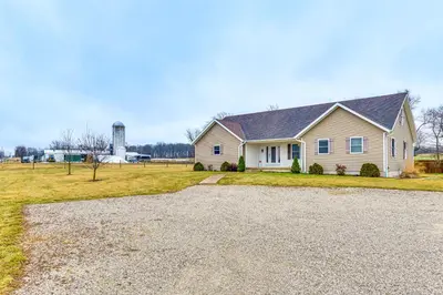 a house with a water tower in the background at Meadow Edges with Yard and Views in Odon in Sunman