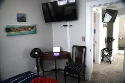 a room with a table and a television on the wall at Werner Haus in Sandusky