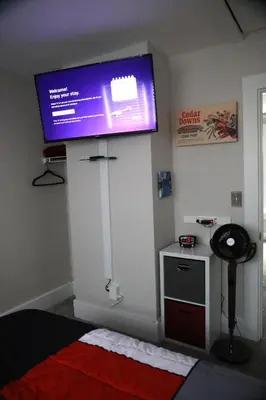 a tv on the wall of a bedroom with a bed at Werner Haus in Sandusky