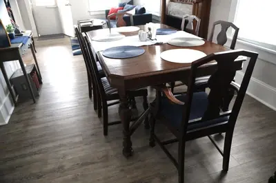 a dining room table with chairs and a wooden floor at Werner Haus in Sandusky