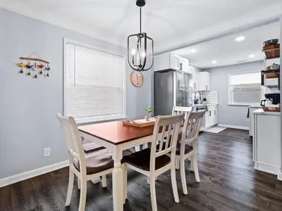 a kitchen and dining room with a table and chairs at Modern 3Bed Home Near CLE With Private Backyard in Parma Heights
