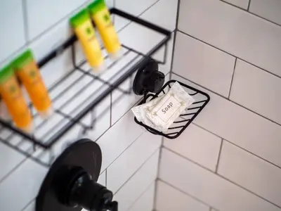 a soap dispenser on a tiled bathroom wall at Modern 3Bed Home Near CLE With Private Backyard in Parma Heights