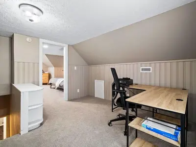 a room with a desk and a bedroom at Modern 3Bed Home Near CLE With Private Backyard in Parma Heights