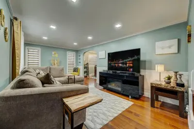 a living room with a couch and a flat screen tv at South Euclid Home 10 Minutes to Cleveland Clinic in South Euclid