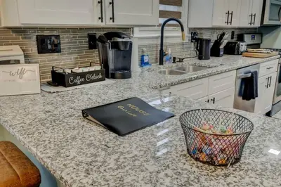 a kitchen counter with a book on top of it at South Euclid Home 10 Minutes to Cleveland Clinic in South Euclid