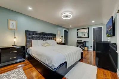a bedroom with a large bed and a television at South Euclid Home 10 Minutes to Cleveland Clinic in South Euclid