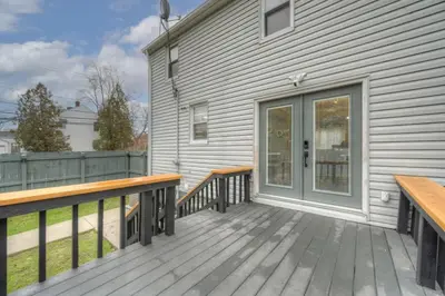 a wooden deck with benches on a house at South Euclid Home 10 Minutes to Cleveland Clinic in South Euclid