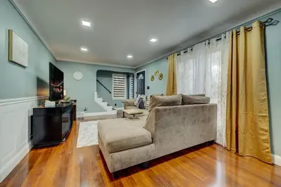 a living room with a couch and a television at South Euclid Home 10 Minutes to Cleveland Clinic in South Euclid