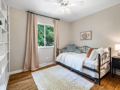 a bedroom with a bed and a window at Large Remodeled 4 Bed 3 Bath Secluded With Hot Tub in Akron