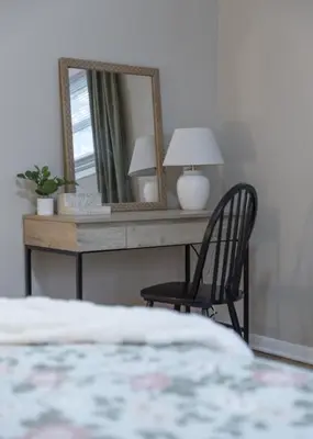 a bedroom with a desk with a mirror and a chair at Hot Tub Game Room with Shuffleboard N64 Sleeps 8 in Parma Heights