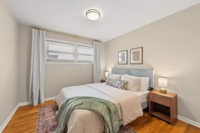 a bedroom with a large bed and a window at Hot Tub Game Room with Shuffleboard N64 Sleeps 8 in Parma Heights