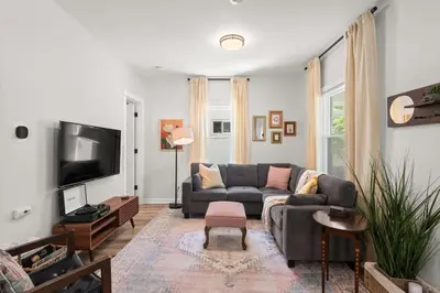 a living room with a couch and a tv at Renovated and Professionally Designed 3Bed Home in Euclid