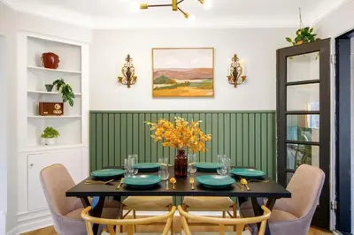 a dining room with a black table and chairs at Newly Remodeled Home With a Game Room in Parma Heights
