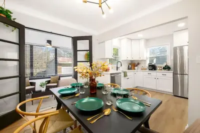 a kitchen with a table with green plates on it at Newly Remodeled Home With a Game Room in Parma Heights