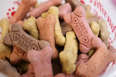 a pile of gingerbread dog biscuits in a basket at Newly Remodeled Home With a Game Room in Parma Heights