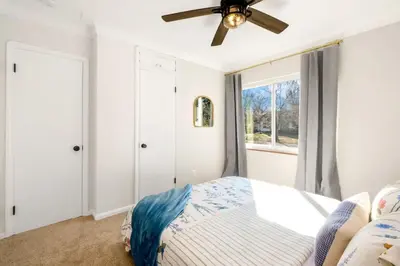 a bedroom with a bed and a ceiling fan at Newly Remodeled Home With a Game Room in Parma Heights