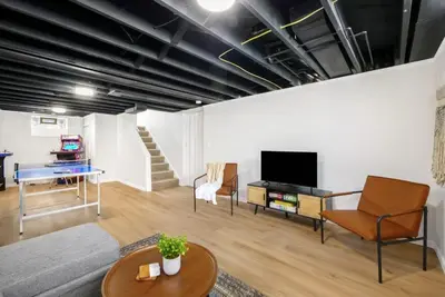 a living room with a couch a table and a tv at Newly Remodeled Home With a Game Room in Parma Heights