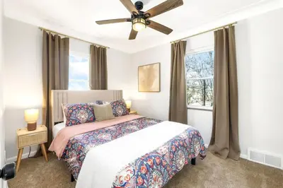 a bedroom with a bed and a ceiling fan at Newly Remodeled Home With a Game Room in Parma Heights