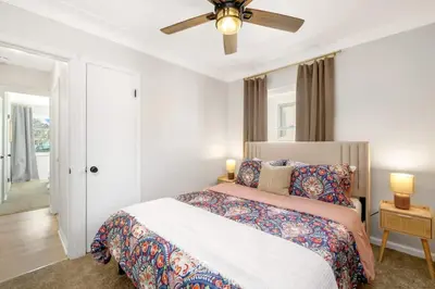 a bedroom with a bed and a ceiling fan at Newly Remodeled Home With a Game Room in Parma Heights