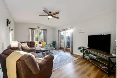 a living room with a couch and a flat screen tv at Natures Retreat Renovated with Quiet Pond Views in Canal Fulton