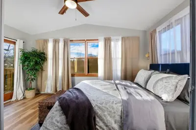 a bedroom with a bed and a ceiling fan at Natures Retreat Renovated with Quiet Pond Views in Canal Fulton