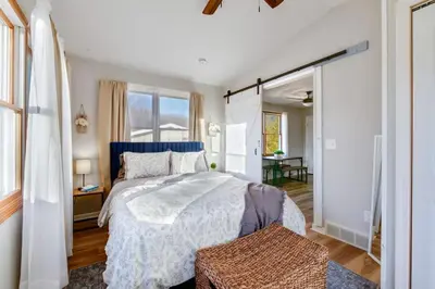 a bedroom with a bed and a large window at Natures Retreat Renovated with Quiet Pond Views in Canal Fulton
