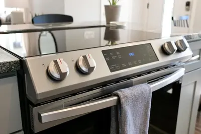 a stove top oven with a towel hanging on it at Remodeled 4 Bedroom With a Game Room in Parma