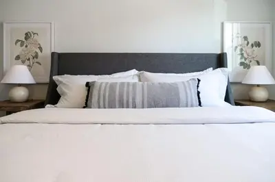 a bedroom with a white bed with two lamps at Remodeled 4 Bedroom With a Game Room in Parma