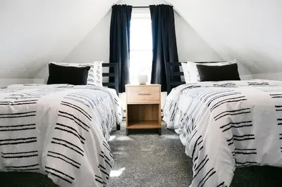 a bedroom with two beds and a window at Remodeled 4 Bedroom With a Game Room in Parma
