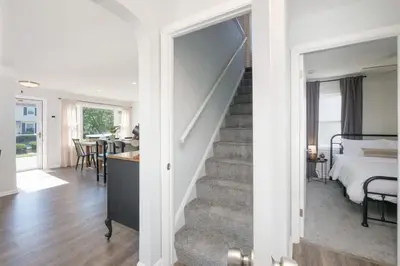 a room with a staircase and a bedroom with a bed at Remodeled 4 Bedroom With a Game Room in Parma