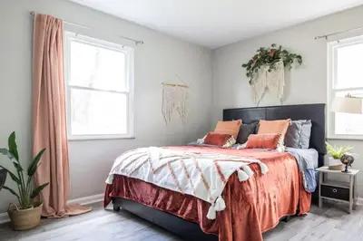 a bedroom with a large bed with orange pillows at Entire Secluded House Close To CLE Airport and BWU in Strongsville
