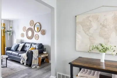 a living room with a couch and a map on the wall at Entire Secluded House Close To CLE Airport and BWU in Strongsville