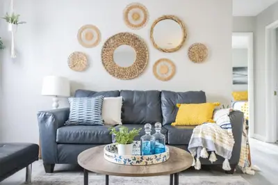 a living room with a blue couch and a table at Entire Secluded House Close To CLE Airport and BWU in Strongsville