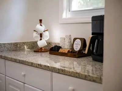 a kitchen counter with a coffee maker and a clock at Game Room 7 Min To Downtown CLE in Cleveland