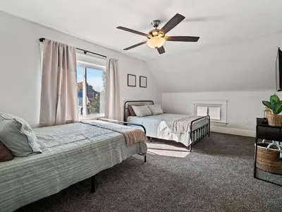 a bedroom with two beds and a ceiling fan at Game Room 7 Min To Downtown CLE in Cleveland