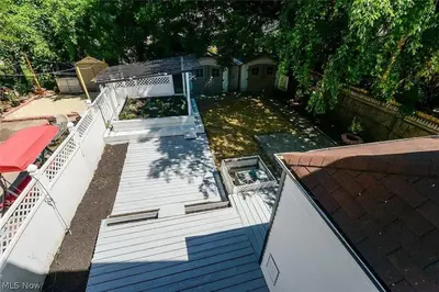 a large white deck with a pool in a yard at Game Room 7 Min To Downtown CLE in Cleveland