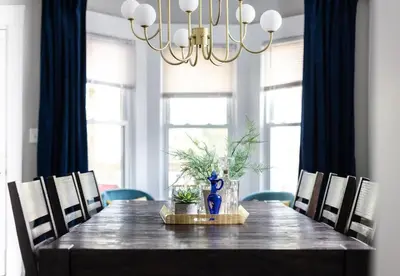 a dining room table with chairs and a chandelier at Large Renovated 4 Bedroom Home 9 min to Downtown CLE in Cleveland