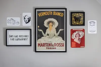 a group of framed posters on a wall at Large Renovated 4 Bedroom Home 9 min to Downtown CLE in Cleveland