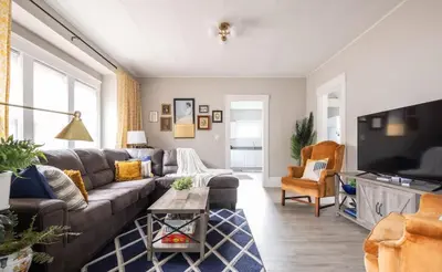 a living room with a couch and a tv at Large Renovated 4 Bedroom Home 9 min to Downtown CLE in Cleveland