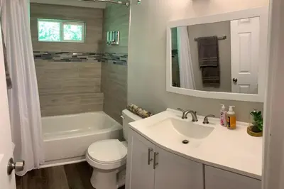 a bathroom with a sink and a toilet and a tub at Filled with warmth and comfort Home away from home in Cincinnati