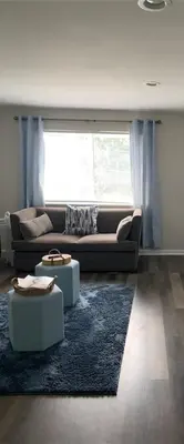 a living room with a couch and two tables at Filled with warmth and comfort Home away from home in Cincinnati
