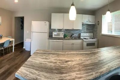 a kitchen with a white refrigerator and a table at Filled with warmth and comfort Home away from home in Cincinnati