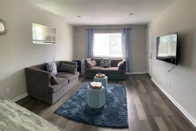 a living room with two couches and a tv at Filled with warmth and comfort Home away from home in Cincinnati