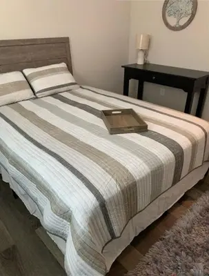 a bed with a wooden tray on top of it at Filled with warmth and comfort Home away from home in Cincinnati