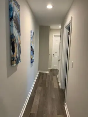 a hallway with two paintings on the walls and a hallway with a hallway at Filled with warmth and comfort Home away from home in Cincinnati