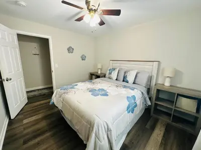 a bedroom with a bed with a ceiling fan at Cozy Retreat Apartment in Cincinnati